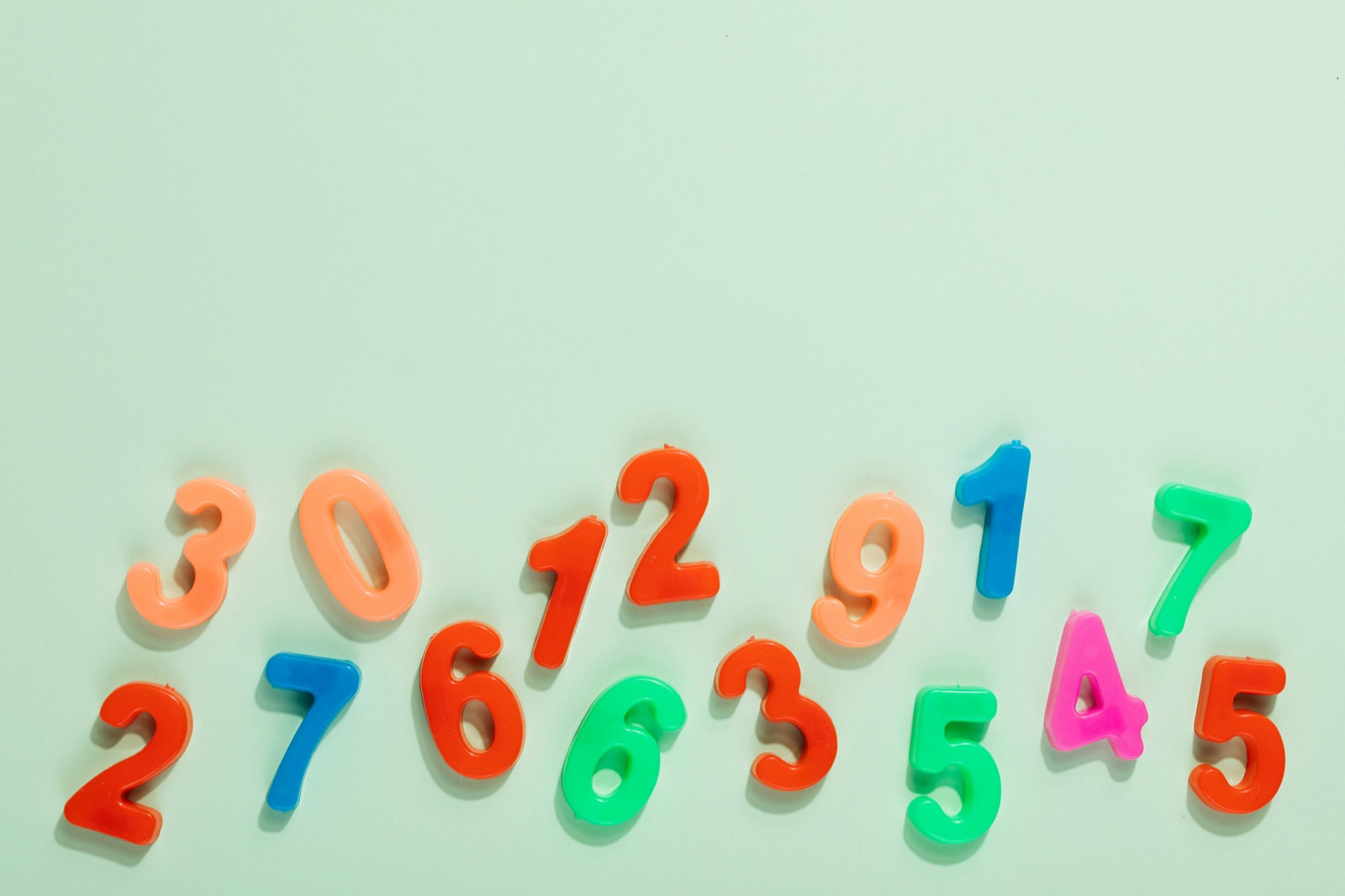 Bright plastic numbers arranged on a light surface for early math exploration.
